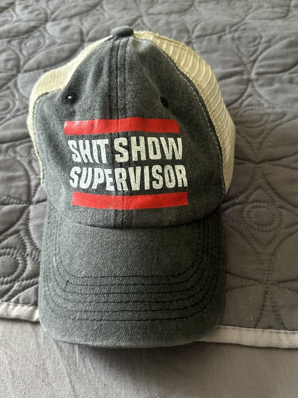 Distressed Trucker Hat bearing the text "SHIT SHOW SUPERVISOR